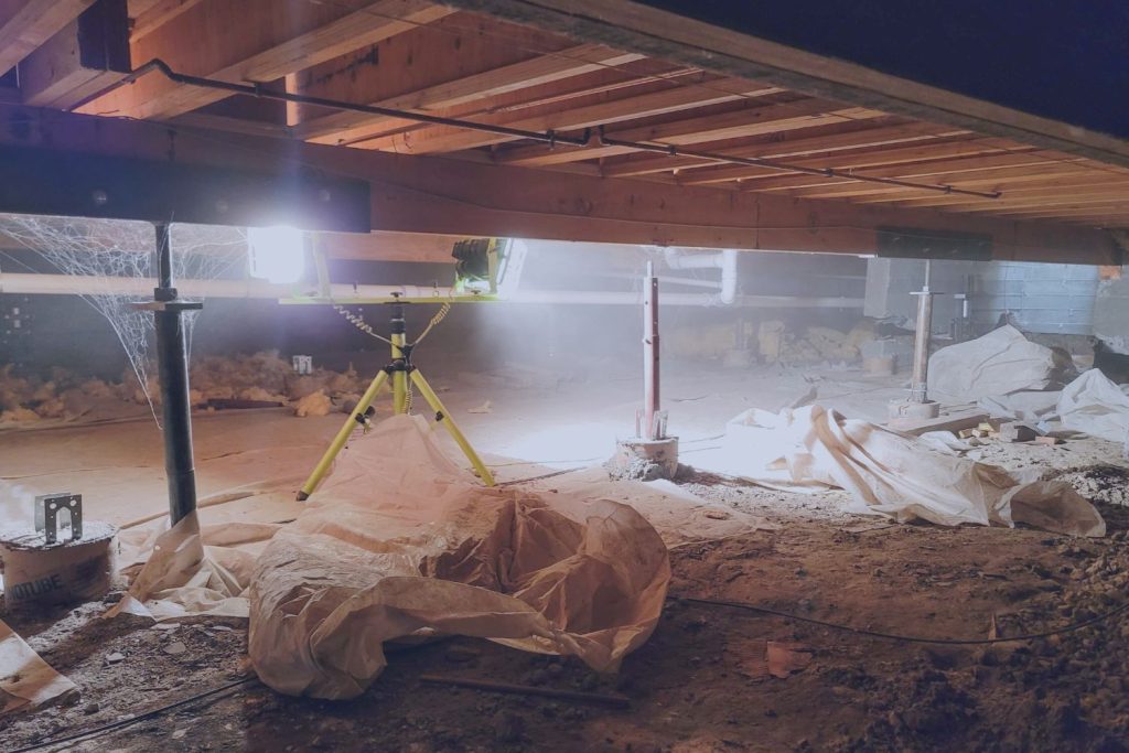 Crawlspace under a Norfolk home showing floor joists and moisture-prone conditions inspected during a home maintenance inspection