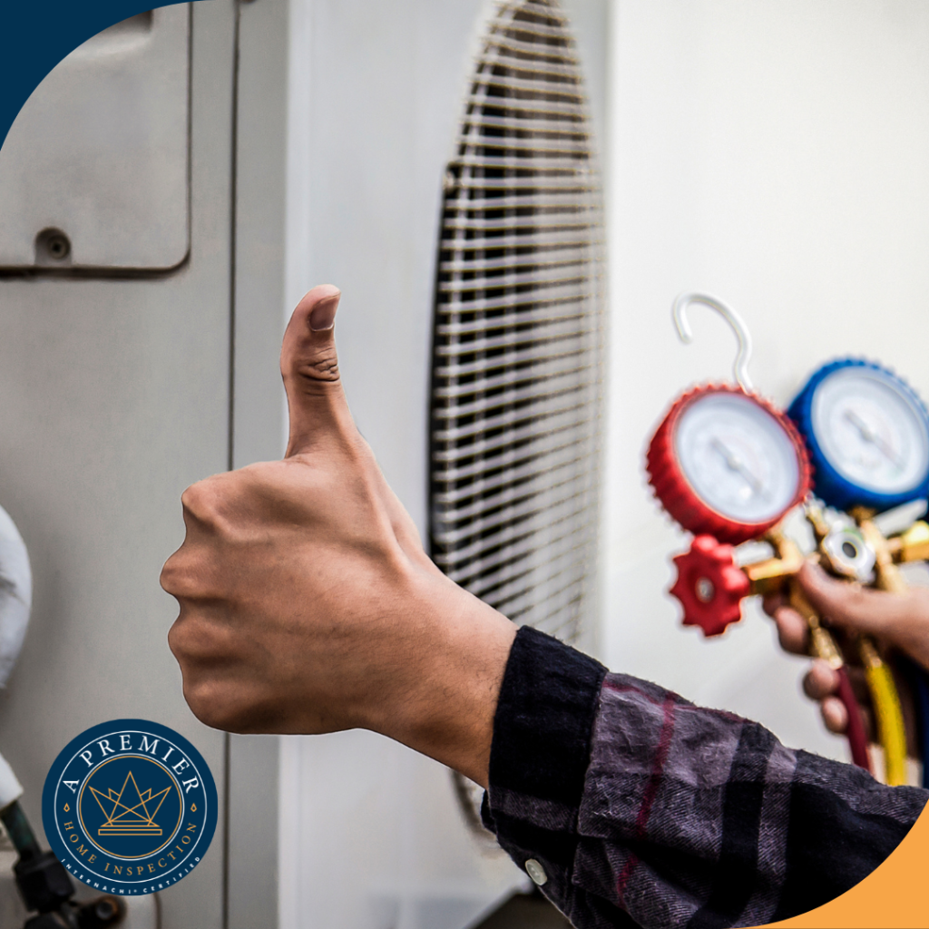 Technician giving a thumbs-up while holding HVAC pressure gauges near an outdoor air conditioning unit.