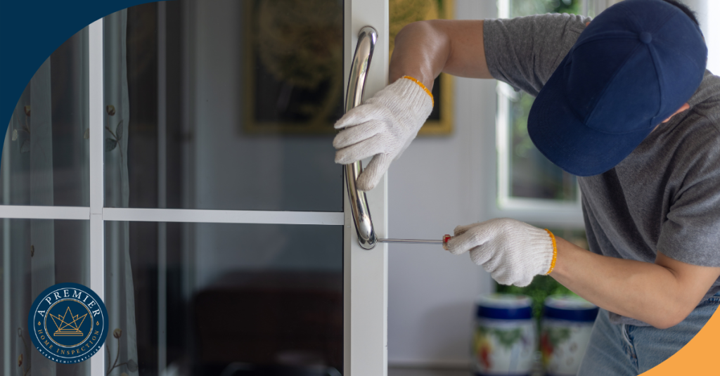 Tightening a door handle with a screwdriver on a glass door.