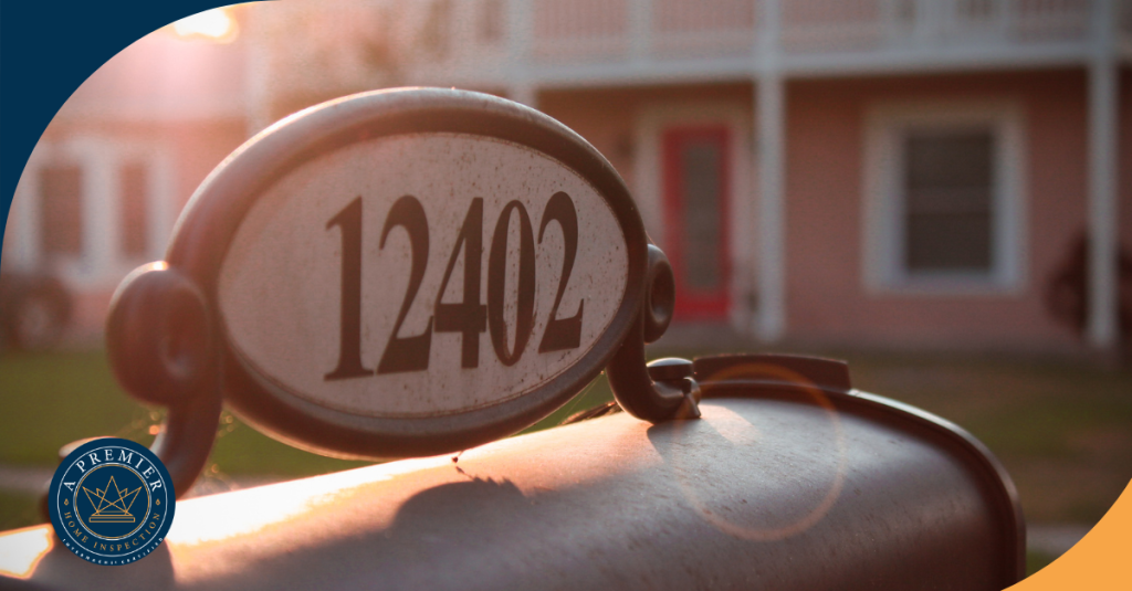 House number 12402 displayed on an oval plaque attached to a mailbox