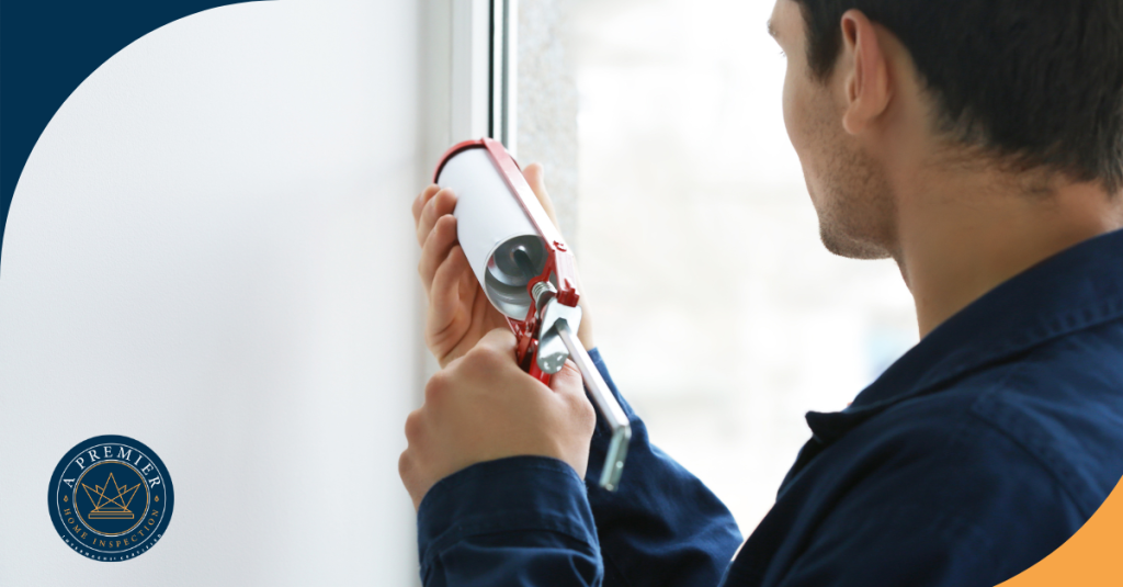 Man applying caulk around a window frame.